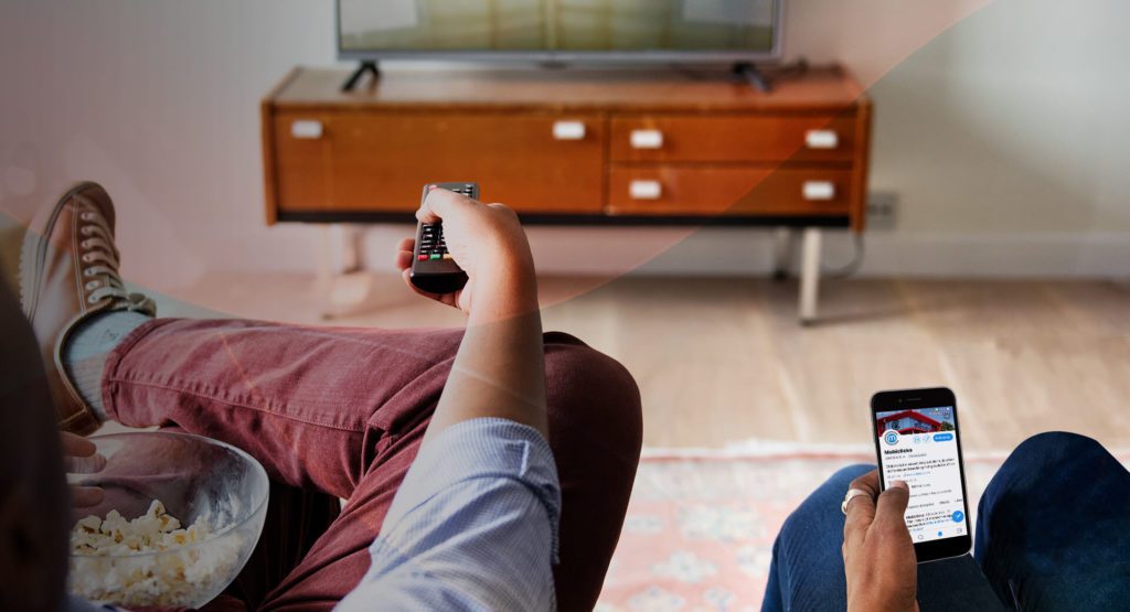People on their phones while watching TV