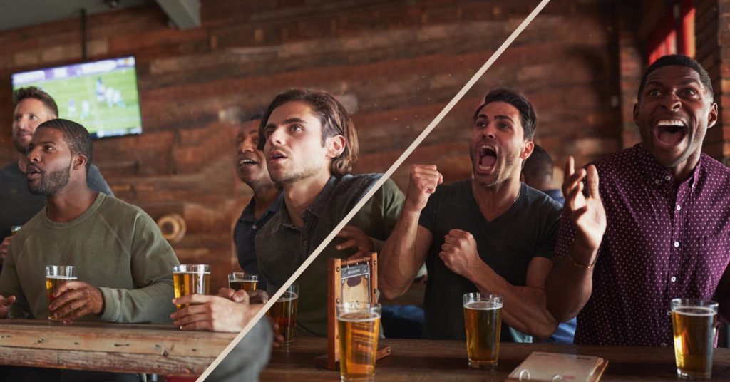 Friends celebrating while watching sport in a pub